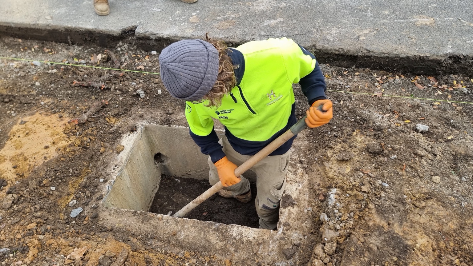 Lucas working in a trench during his plumbing apprenticeship.